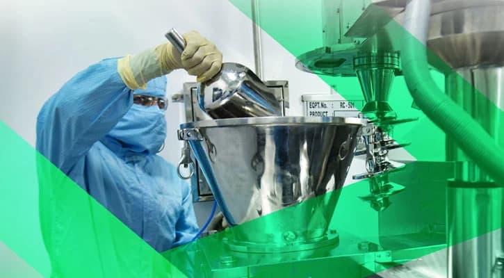 Cleanroom operator in a blue gown and mask handling a stainless steel hopper during peptide API manufacturing