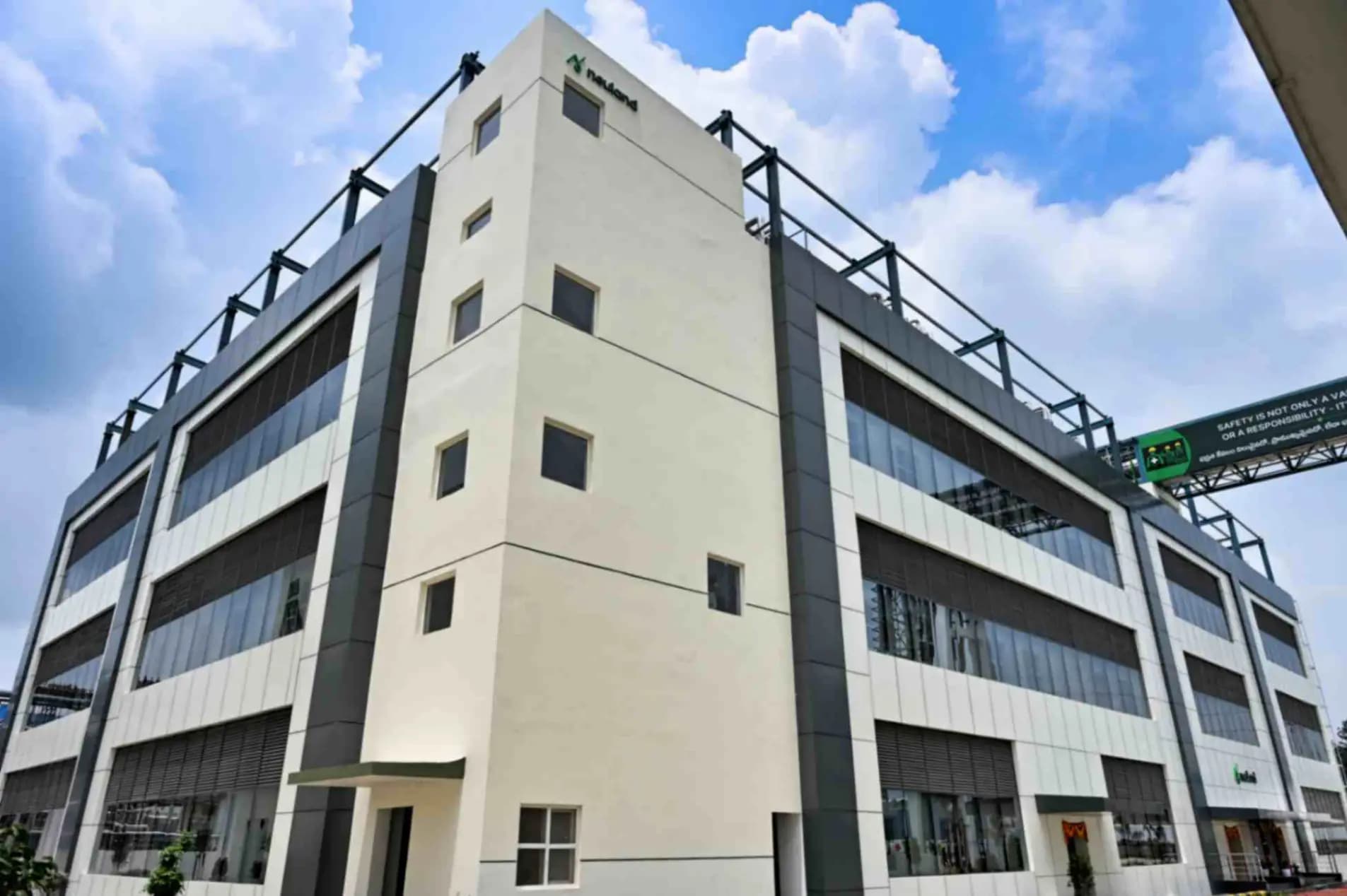 Exterior of the Neuland peptide manufacturing facility, a multi-storey building under a blue sky