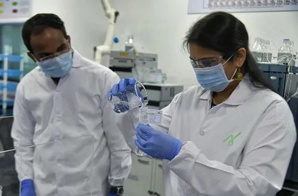 Two scientists in the process of custom manufacturing of APIs